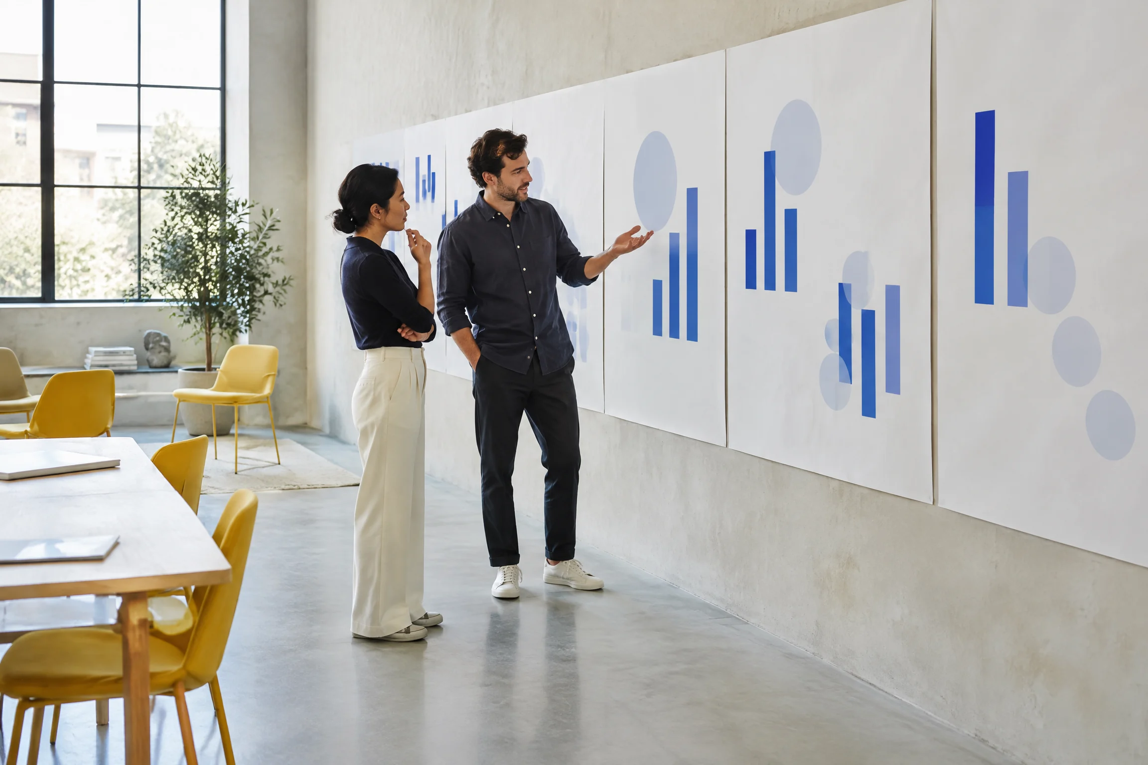 Two professionals reviewing an abstract evidence wall